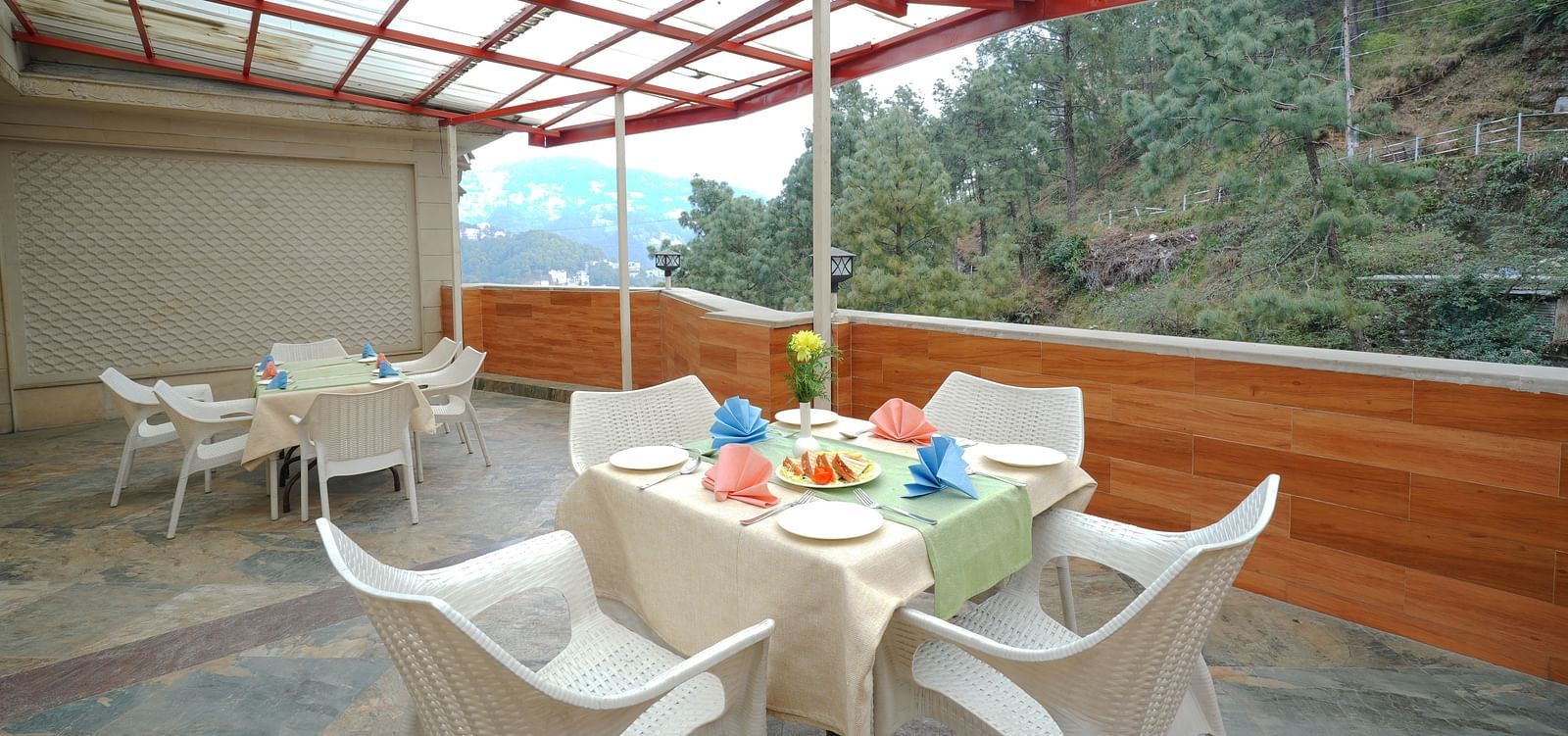 Dining setup on the terrace with cutlery placed on the table at DLS Hotels The Rock Castle.